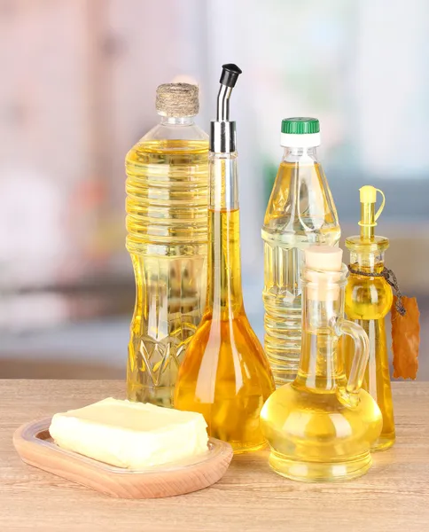 Different types of oil on table in kitchen — Stock Photo, Image