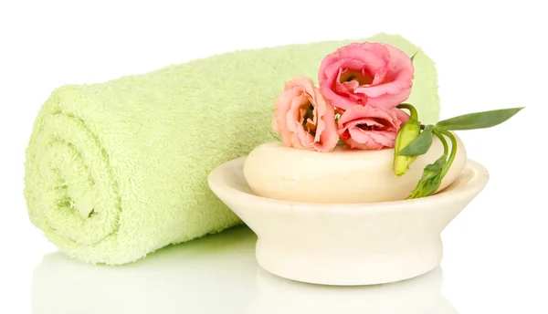 Rolled green towel, soap bar and beautiful flower isolated on white — Stock Photo, Image