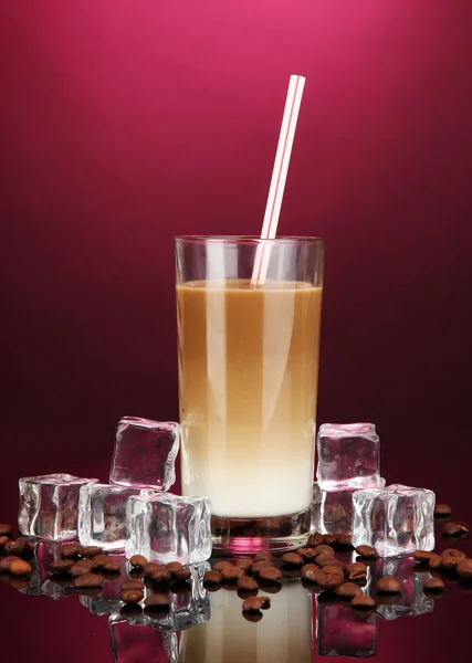 Cold coffee with ice in glass on color background — Stock Photo, Image