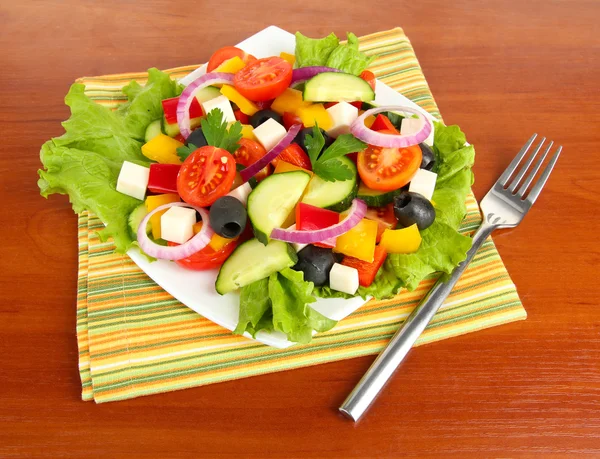 Tasty Greek salad on wooden background — Stock Photo, Image