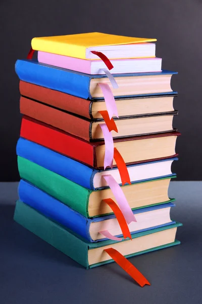 Many books with bookmarks on gray background — Stock Photo, Image