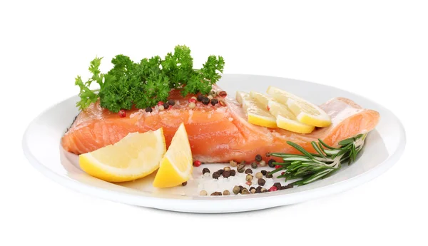 Fresh salmon fillet with herbals and lemon slices on plate, isolated on white — Stock Photo, Image