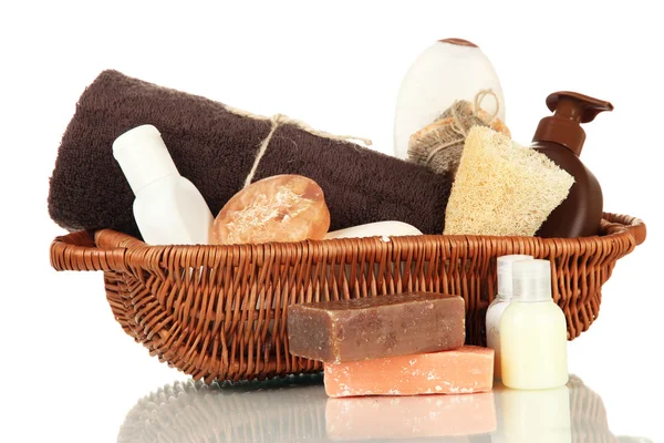 Composition of cosmetic bottles and soap in basket, isolated on white — Stock Photo, Image