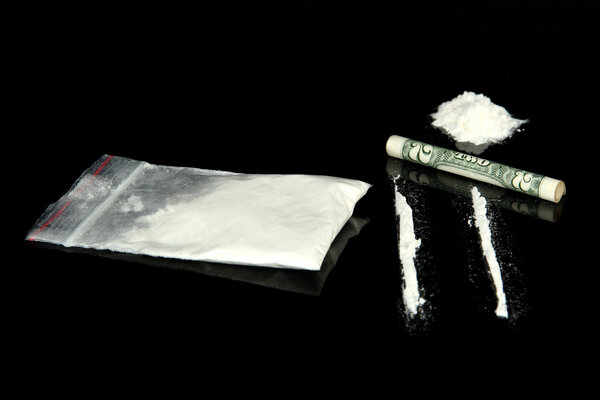 Cocaine drugs heap and lines with rolled banknote, close up