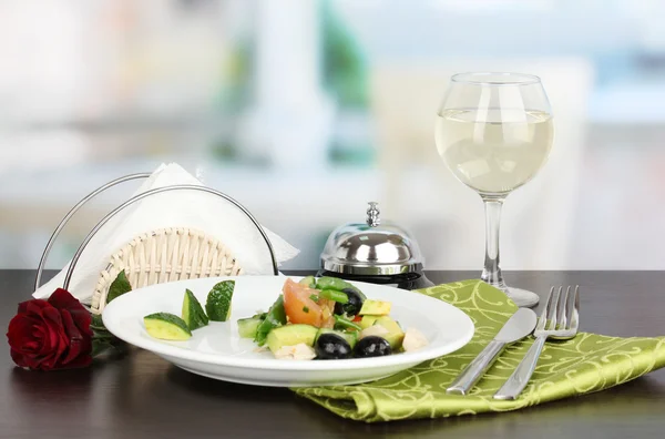 Вкусный салат авокадо в миске на деревянном столе на фоне ресторана — стоковое фото