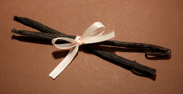 Vanilla pods on brown background — Stock Photo, Image