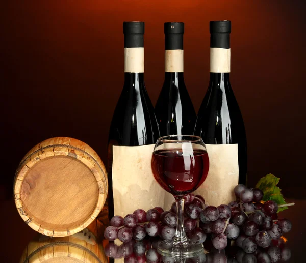 Composição de vinho, barril de madeira e uva, sobre fundo vermelho escuro — Fotografia de Stock