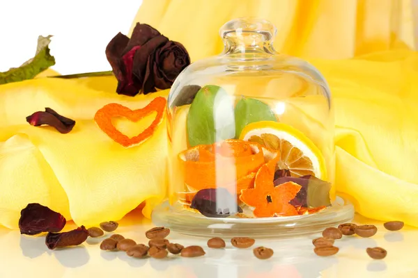 Decorative rose from dry orange peel in glass vase on yellow fabric background — Stock Photo, Image