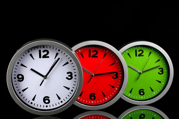 Round office clocks on black background — Stock Photo, Image