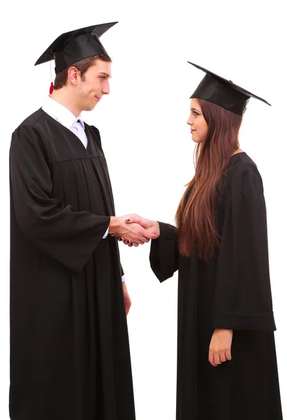 Due felici studenti laureati isolati su bianco — Foto Stock