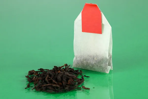 Tea bag on green background — Stock Photo, Image