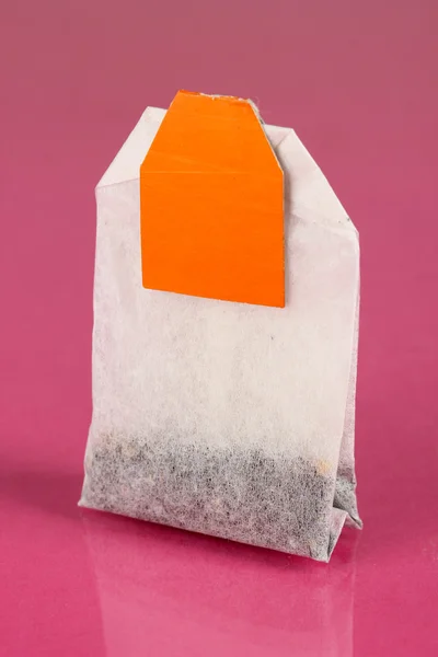 Tea bag on pink background — Stock Photo, Image