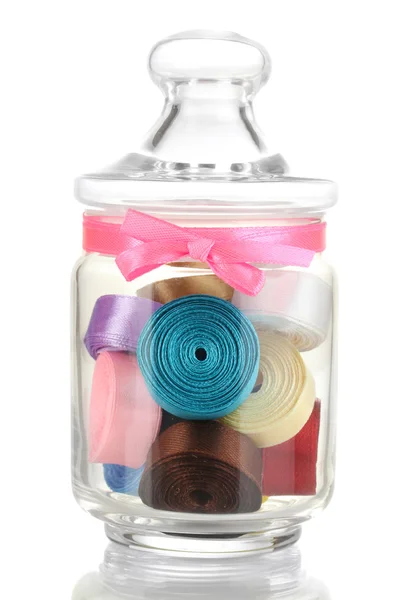 Glass jar containing various colored ribbons isolated on white — Stock Photo, Image