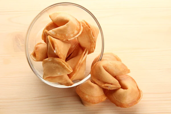 Fortune cookies in bowl, on wooden table — Stock Photo, Image