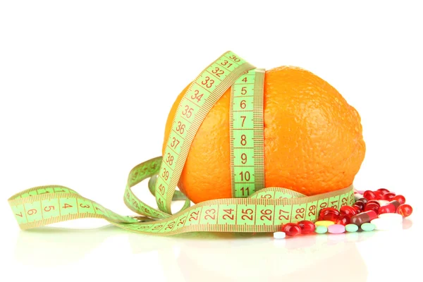 Orange with measuring tape and multicolor pills, isolated white — Stock Photo, Image