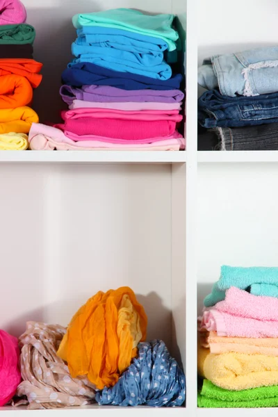 Clothes neatly folded on shelves — Stock Photo, Image