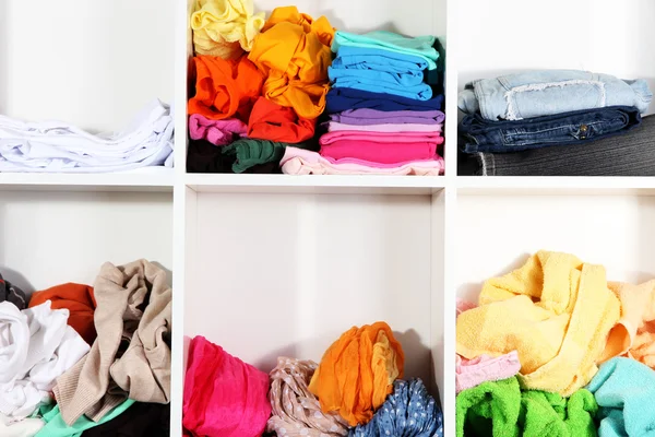 Clothing scattered on shelves — Stock Photo, Image