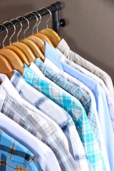 Men's shirts on hangers on gray background — Stock Photo, Image