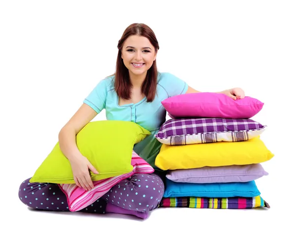 Beautiful young girl with pillows isolated on white — Stock Photo, Image