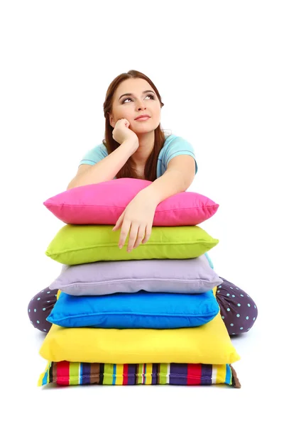 Beautiful young girl with pillows isolated on white — Stock Photo, Image