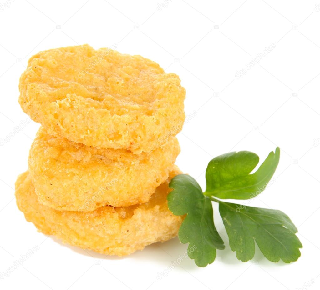 Fried chicken nuggets with parsley isolated on white