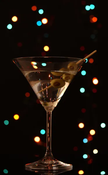 Martini glass and olives on dark bright background — Stock Photo, Image