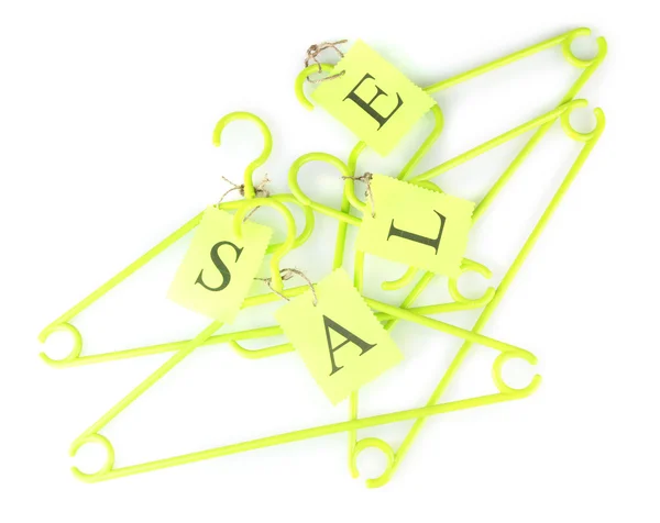 Coat hangers with sale tag isolated on white background — Stock Photo, Image