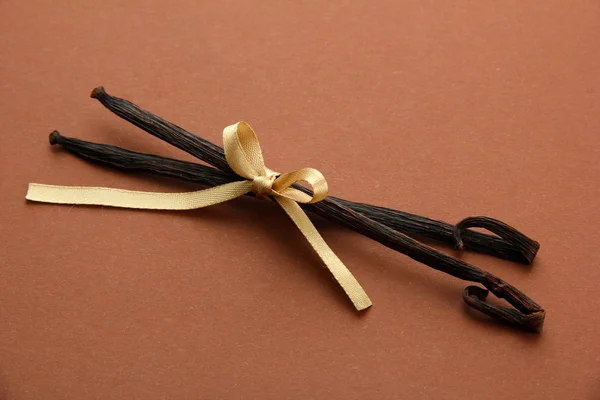 Vanilla pods on brown background — Stock Photo, Image