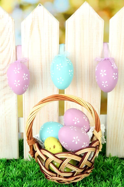 Art Easter background with eggs hanging on fence — Stock Photo, Image