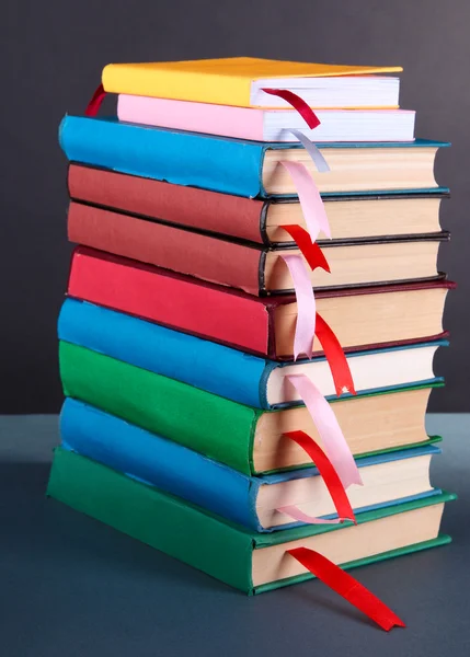 Many books with bookmarks on gray background — Stock Photo, Image