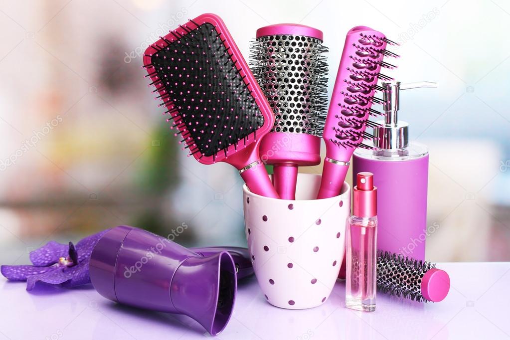 Hair brushes, hairdryer and cosmetic bottles in beauty salo