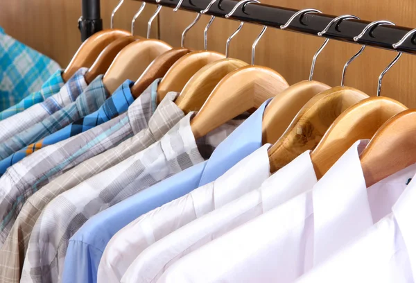 Men's shirts on hangers in wardrobe — Stock Photo, Image