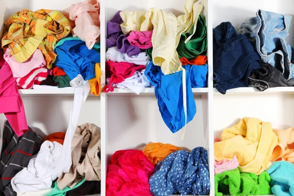 Clothing scattered on shelves — Stock Photo, Image