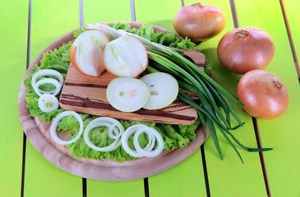 Composition with herbs and onions on wooden table — Stock Photo, Image