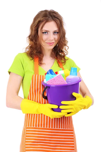 Young housewife with bucket of cleaning supplies, isolated on white — Stock Photo, Image