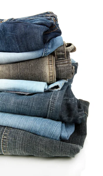 Lot of different jeans isolated on white — Stock Photo, Image