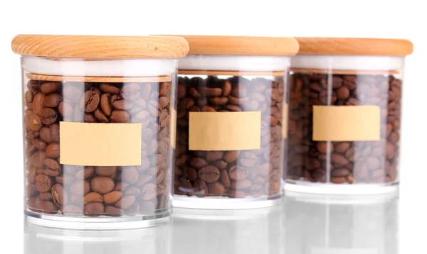 Granos de café en frascos aislados en blanco —  Fotos de Stock