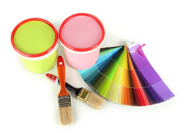 Paint pots, paintbrushes and coloured swatches isolated on white — Stock Photo, Image