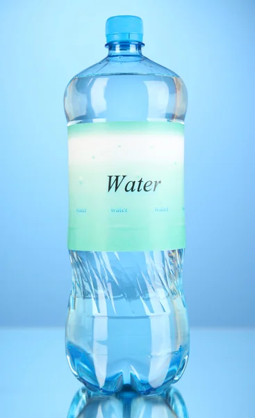 Water bottle with label on blue background — Stock Photo, Image