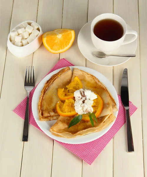 Pancakes with orange on wooden table — Stock Photo, Image