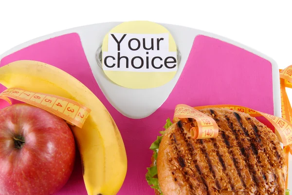 Burgers and fruit on the scale close-up — Stock Photo, Image