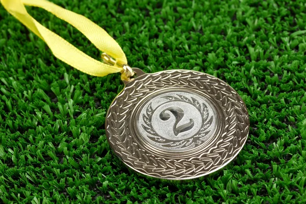 Silver medal on grass background — Stock Photo, Image