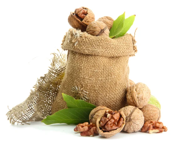 Walnuts with green leaves in burlap bag, isolated on white — Stock Photo, Image