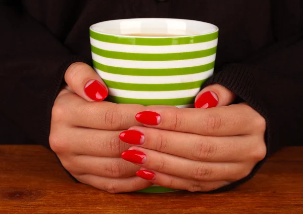 Hände halten Becher mit Heißgetränk, Nahaufnahme — Stockfoto