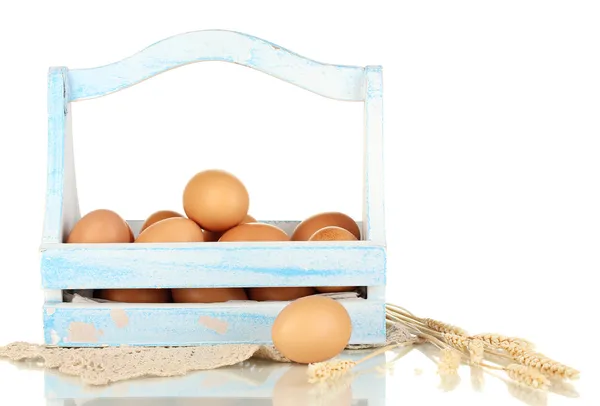 Eggs in blue wooden basket isolated on white — Stock Photo, Image