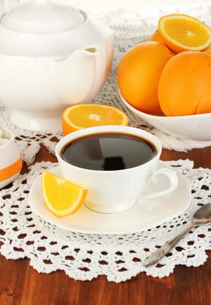 Beautiful white dinner service with oranges on wooden table close-up — Stock Photo, Image