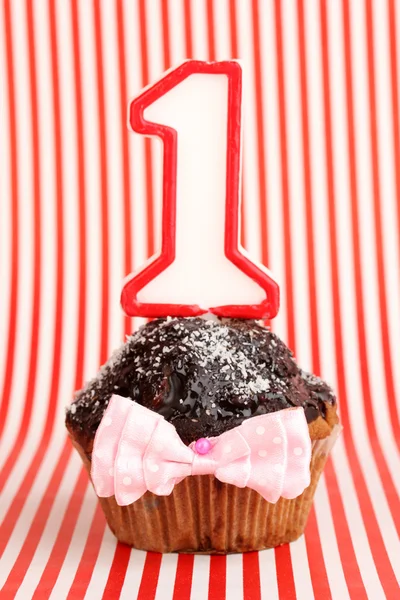 День рождения кекс с шоколадной глазурью на полосатом фоне — стоковое фото