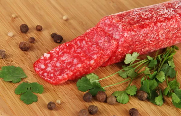 Tasty salami on wooden board close-up — Stock Photo, Image