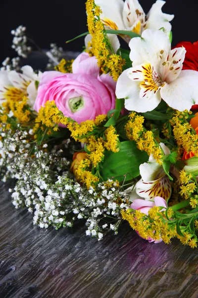 Bouquet of various flowers on dark background — Stock Photo, Image