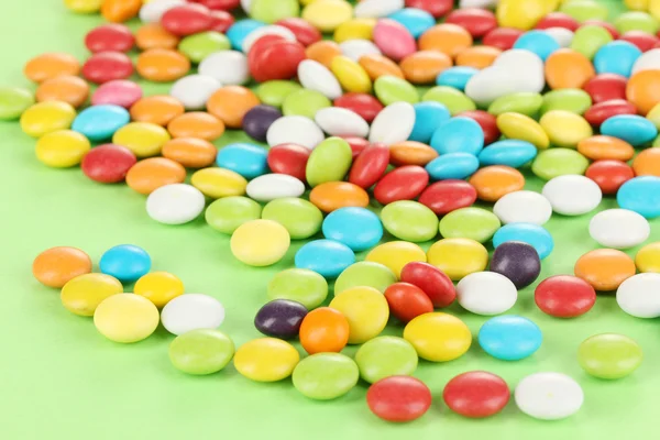 Bunte Bonbons auf grünem Hintergrund — Stockfoto